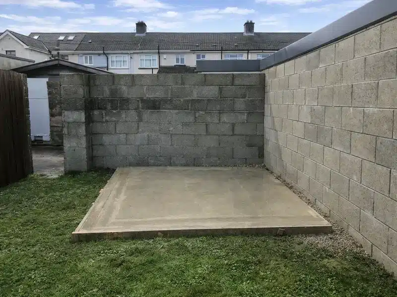 Finished concrete shed base built against a wall in Dublin