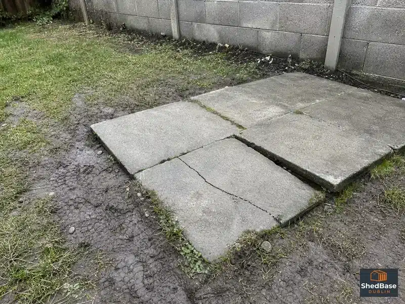 Cracked thin paving slab on a failed shed base laid without a proper sub-base in Dublin