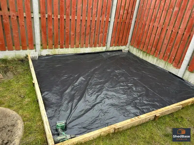 DPM membrane laid over a compacted sub-base inside timber formwork for a shed base in Lucan, Dublin