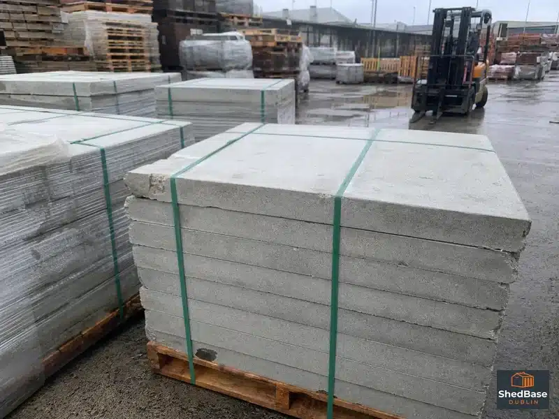 Stacked packs of budget 600mm concrete paving slabs at a Dublin builders merchant yard