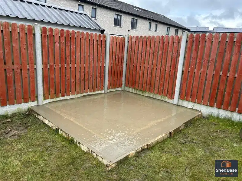 Freshly poured concrete base in a corner of a Lucan back garden with timber shuttering